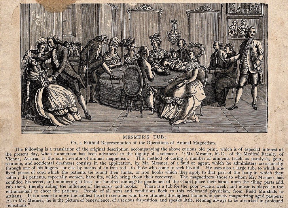 Period engraving of a mesmerist salon: patients seated around the baquet tub, holding iron rods and connected by ropes, while operators make magnetic passes.