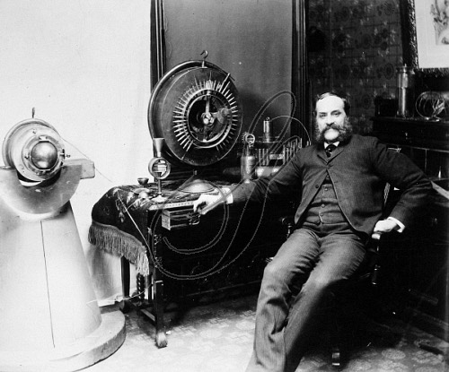 Photograph of John Worrell Keely beside his apparatus, circa 1895.